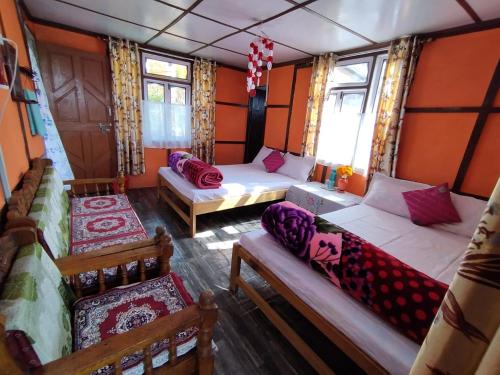 a room with two beds and a couch in a bus at Hillsation Thulung Homestay in Kalimpong
