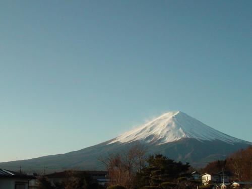 a snow covered mountain in the distance with a blue sky at Fujimien in Fujikawaguchiko