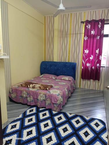 a small bedroom with a bed and a window at D&I Homestay in Tumpat