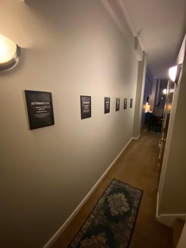 a hallway with pictures on a white wall at Downtown CLE Loft, River View, King Bed, Free Parking in Cleveland