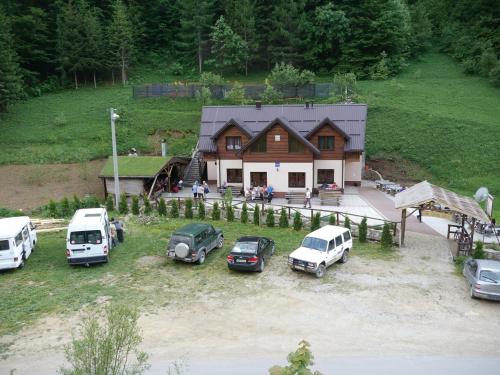 a group of cars parked in front of a house at Motel Luka in Deževice