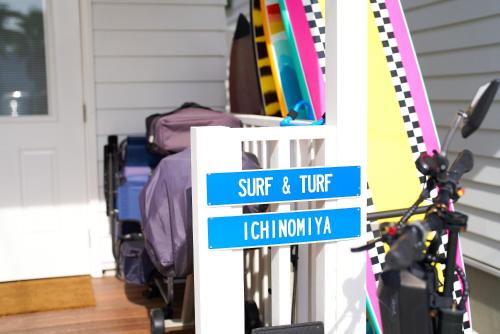 a sign in front of a door with luggage at Surf & Turf Ichinomiya East - 九十九里 サーフ&ターフ一宮イースト in Ichinomiya
