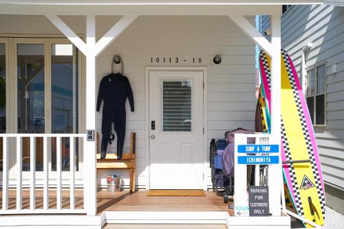 a front porch of a house with a white door at Surf & Turf Ichinomiya East - 九十九里 サーフ&ターフ一宮イースト in Ichinomiya