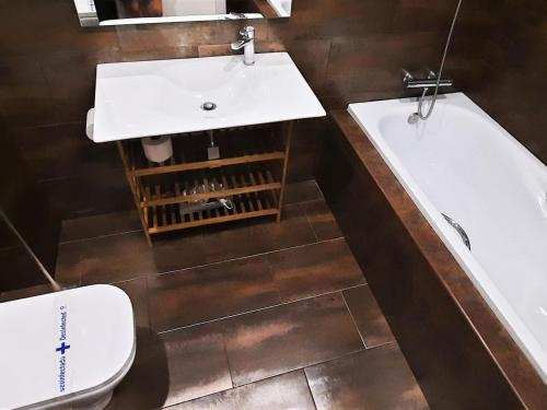a bathroom with a sink and a tub and a toilet at Apartamento Llançà, 1 dormitorio, 4 personas - ES-170-5 in Llança