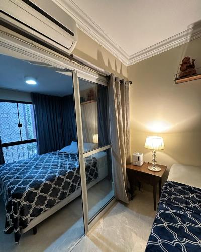 a bedroom with a bunk bed and a desk with a lamp at Comfortable & Economic Acqua Village in Brasilia