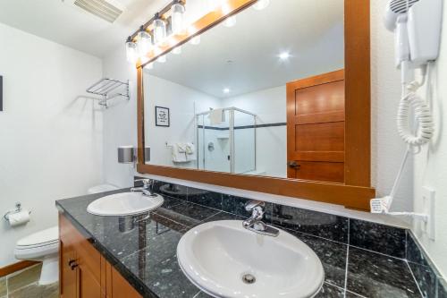 a bathroom with two sinks and a mirror at Luxurious Remodeled Village Oasis in Mammoth Lakes