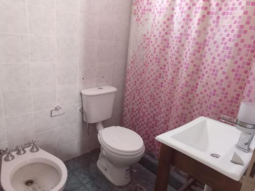 a bathroom with a toilet and a sink at Salta 869 in Mar de Ajó