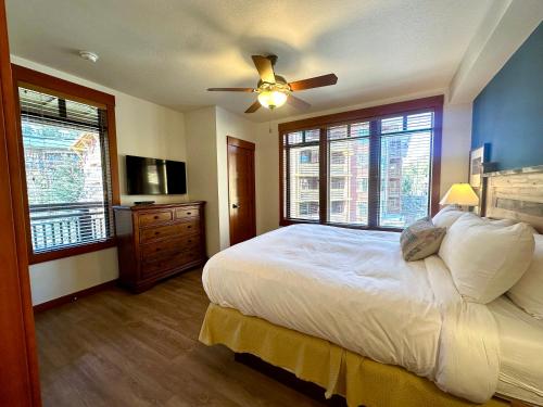 a bedroom with a bed and a ceiling fan at Quiet, Updated, Corner Condo in the Village! Parking, Pool & Spa in Mammoth Lakes