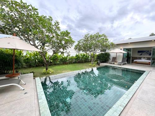 a swimming pool in the backyard of a house at Lada Pool Villa in Bang Tao Beach