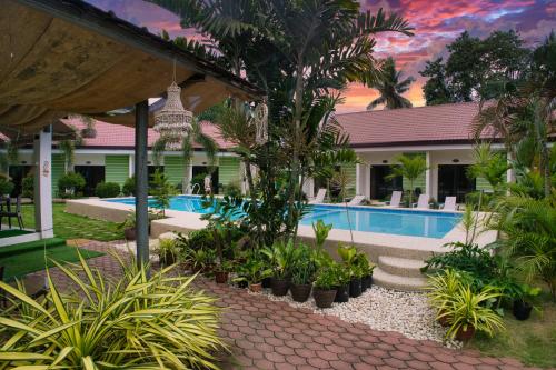 a villa with a swimming pool and a resort at Chinita Boutique Hotel in Panglao