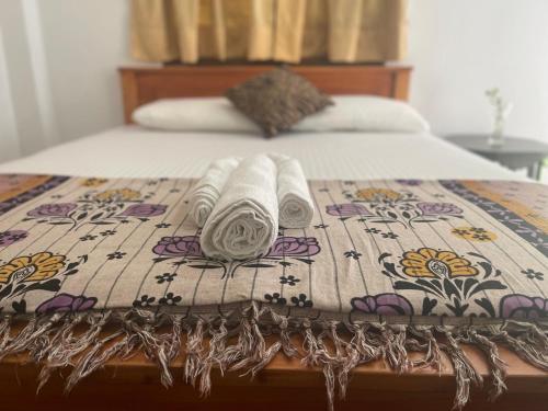 a bed with two towels on top of it at Eagles Eco Lodge - Kandy in Digana