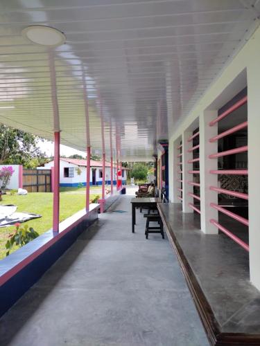 a hallway of a building with a table and benches at FINCA HOTEL LA BONITA BY LA MACORINA in Quimbaya
