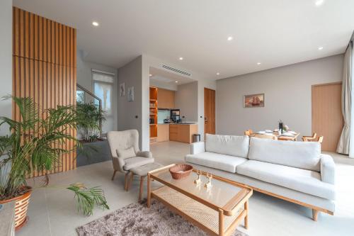a living room with a couch and a table at New 3BR Pool Villa Long One A5 with Chalong Bay view in Chalong