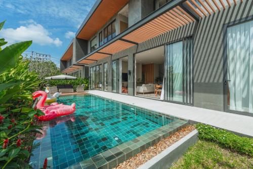 a swimming pool with an inflatable pool toy in a house at New 3BR Pool Villa Long One A5 with Chalong Bay view in Chalong