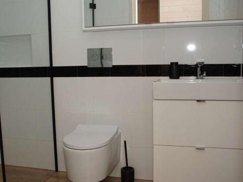 a bathroom with a white toilet and a sink at Comfortable holiday home, Mielenko in Mielenko