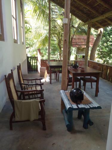 a patio with wooden tables and chairs and a table at Home in the Island in Tangalle