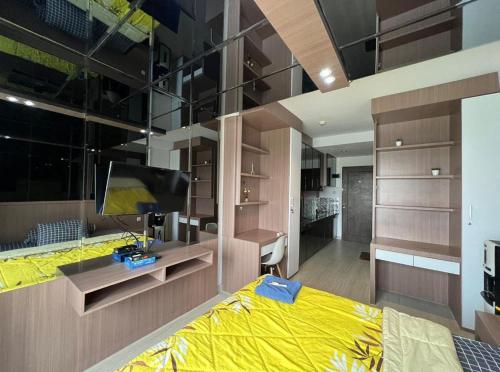 a bedroom with a large yellow bed and a desk at Skyview Setiabudi Apartment in Sunggal