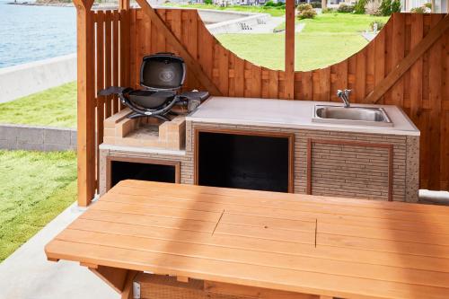 a outdoor kitchen with a table and a sink at &SUN Hung five in Minamiboso