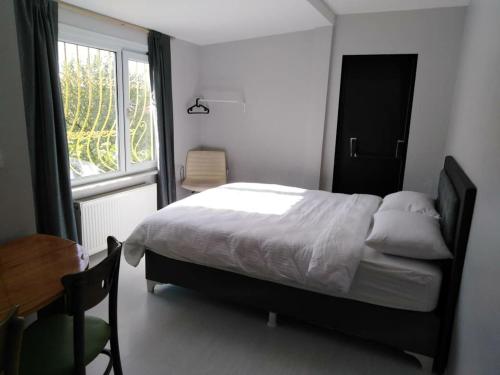 a bedroom with a bed and a desk and a window at RAZI TURIZM in Istanbul