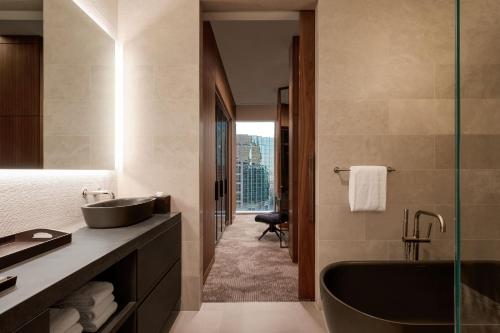 a bathroom with a sink and a bath tub at JW Marriott Dallas Arts District in Dallas