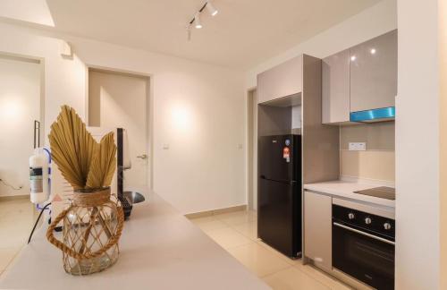 a kitchen with a vase with a plant on a counter at 10 min to My town family unit By Nexx Field in Kuala Lumpur