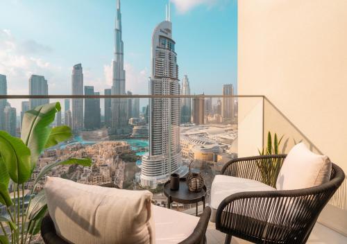 a balcony with chairs and a view of a city at BURJ ROYALE - Luxury 2 bedroom apartment with full burj Khalifa & fountain view- DELUXE in Dubai