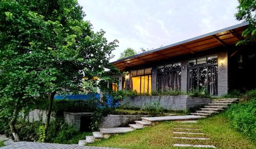 a house with a pathway leading to the front of it at Villa Ba Vi 6 Bedrooms & Pool DC Green Resort in Hanoi