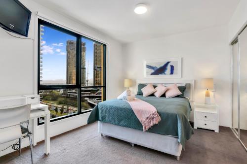 a bedroom with a bed and a large window at Glam & Stylish Broadbeach 2BR Apartment in Gold Coast