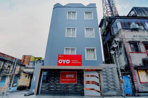 a tall blue building with aww sign in front of it at Hotel O Tranquil Stay in Kolkata