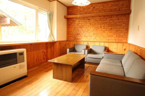 a living room with a couch and a table at Cottage All Resort Service / Vacation STAY 8435 in Inawashiro
