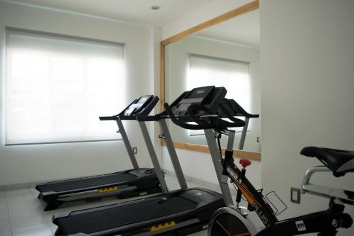 a room with two exercise bikes and a mirror at Hotel México Inn Express in Salamanca