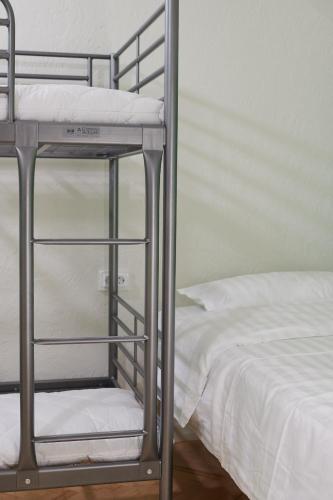 a bunk bed with a ladder next to a bed at Lama Hostel in Ivano-Frankivsʼk