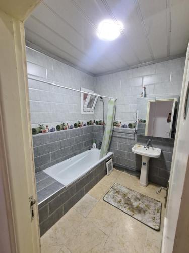 a bathroom with a bath tub and a sink at Cité 200 logement lpp mimouni borj el Kiffan alger in Fort de lʼEau
