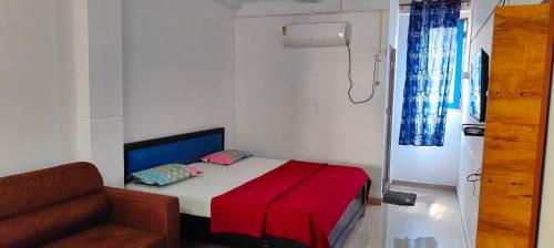 ein kleines Schlafzimmer mit einem Bett und einem Sofa in der Unterkunft OYO Flagship Heaven Stay in Chennai