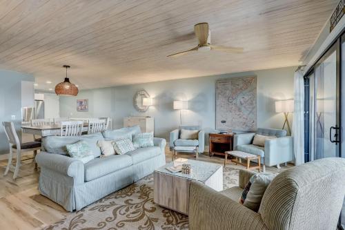 a living room with two couches and a table at Amelia The Sea - 442 ASea in Fernandina Beach