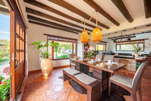 an open kitchen with a large wooden table and chairs at Casa de las Flores in Villa de Leyva