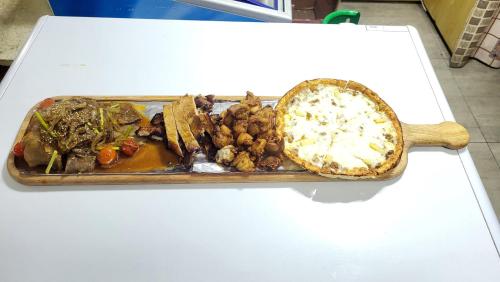 a tray of food on a table with a plate of food at Kharkhorin hostel in Harhorin
