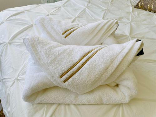 a pile of towels sitting on top of a bed at Luxury loft with a pool in the centre in Torremolinos