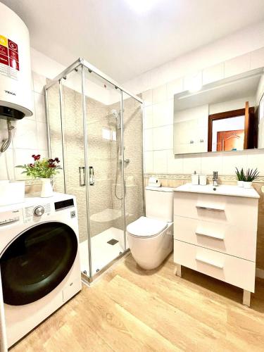 a bathroom with a shower and a toilet and a sink at Luxury loft with pool in the centre in Torremolinos