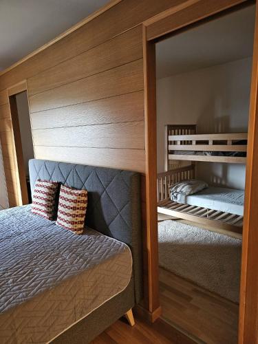 a bedroom with a bed and a large mirror at Apartment Ad Alta Millstatt in Millstatt
