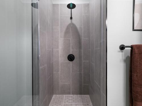 a shower with a glass door with a tile floor at Stunning 2BR Condo in Assembly Square East Somerville in Somerville