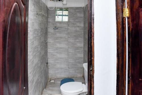 a bathroom with a toilet and a shower at Davis Homes in Kitale