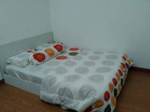 a bed in a room with a white and red at AD Homestay Kuantan in Kuantan