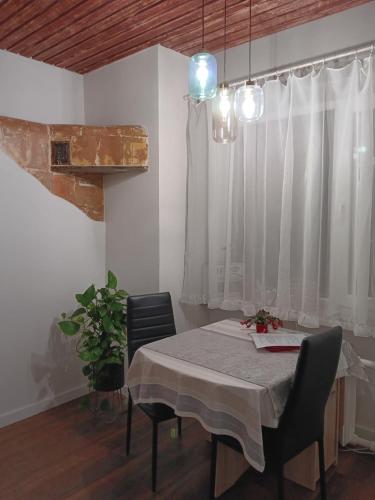 a dining room with a table and chairs and a window at Pilve apartment in Võru