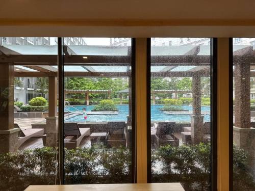 a view of a swimming pool through a window at Airport NAIA Terminal 3 Insane Interior in Manila