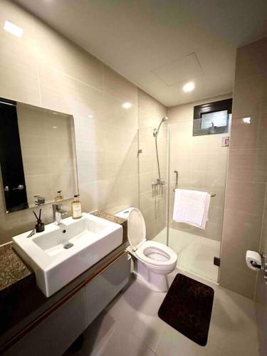 a bathroom with a sink and a toilet and a shower at Airport NAIA Terminal 3 Insane Interior in Manila