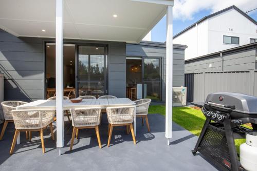 a patio with a table and chairs and a grill at Kirkland - Pet Friendly - 5 Mins Walk to Beach in Culburra Beach