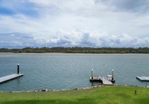 a dock on a large body of water at O'Grady's Rest in Yamba