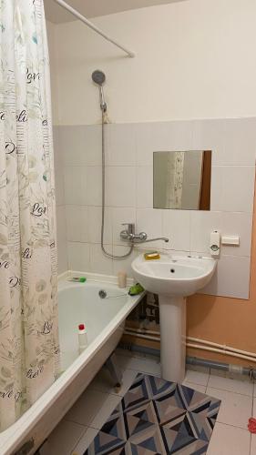 a bathroom with a sink and a toilet and a tub and a sink at Квартира in Oral