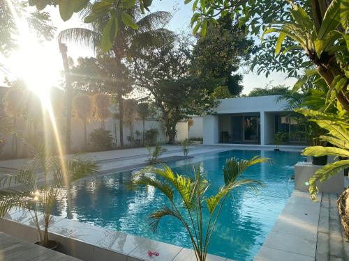 an image of a swimming pool in a garden at Ayom Suite in Mataram